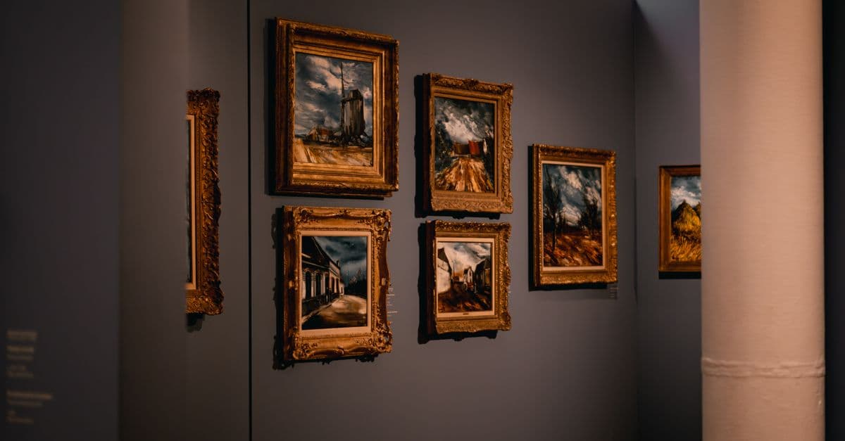 Framed landscape photographs on a gallery wall