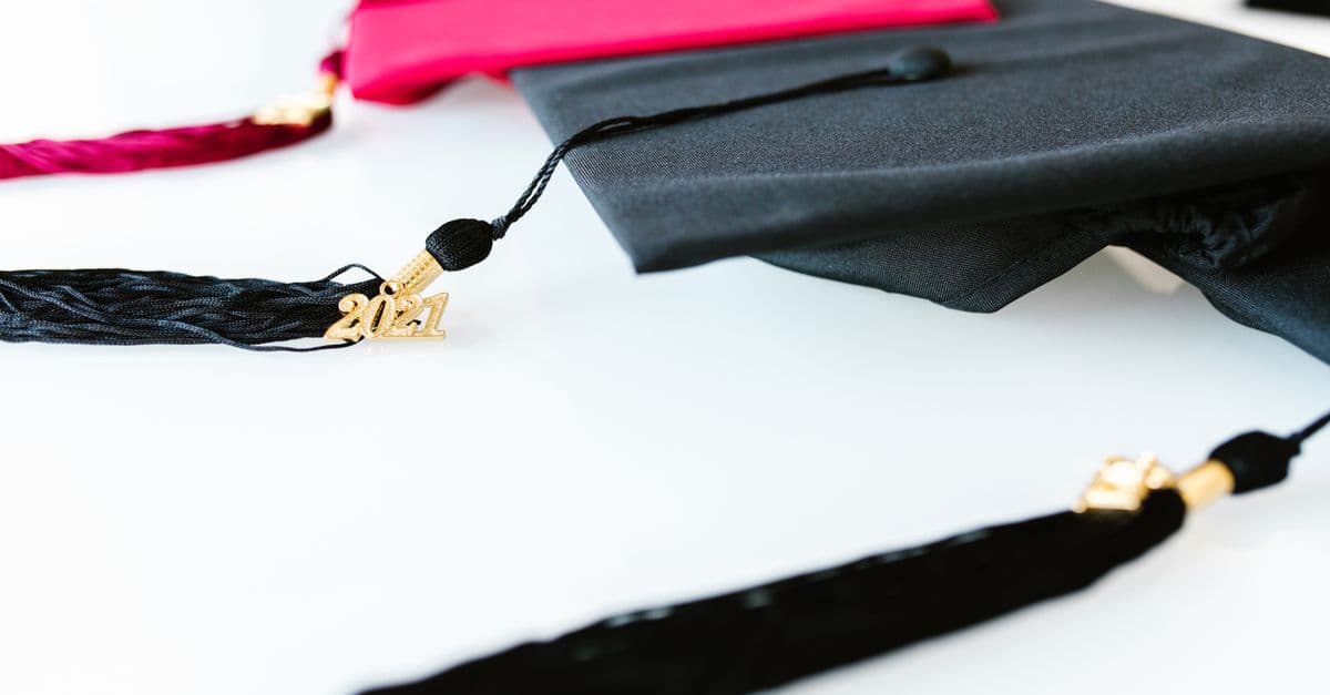 A graduation cap resting on a stack of books